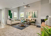 Thumbnail 17 of 25 - A living room with a couch, chairs, and a rug.