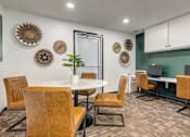 Thumbnail 7 of 25 - A room with a white table surrounded by chairs and a green wall.