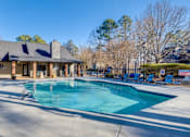 Thumbnail 2 of 25 - A large swimming pool in front of a house.