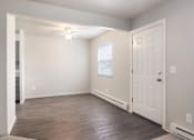 Thumbnail 9 of 10 - A room with a white door, a window with blinds, and a ceiling fan.