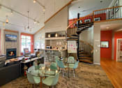 Thumbnail 8 of 12 - a large living room with a spiral staircase and a dining table at Village Club on Franklin, Michigan, 48034