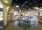 Thumbnail 17 of 47 - a room with a ping pong table in the middle at Village Club of Rochester Hills, Michigan, 48317