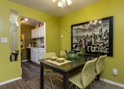 Thumbnail 3 of 47 - a dining room with a table and chairs and a painting on the wall at Village Club of Rochester Hills, Michigan, 48317