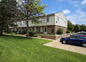 Thumbnail 6 of 47 - a house with a blue car parked in front of it at Village Club of Rochester Hills, Shelby Township, 48317