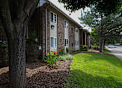 Thumbnail 7 of 47 - side view of the building with a lawn and trees at Village Club of Rochester Hills, Shelby Township Michigan