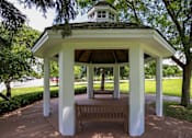 Thumbnail 12 of 47 - a gazebo in a park with a bench at Village Club of Rochester Hills, Shelby Township, MI