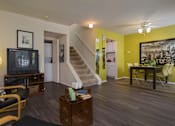 Thumbnail 42 of 47 - a living room with yellow walls and a staircase at Village Club of Rochester Hills, Michigan, 48317