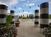 Thumbnail 28 of 47 - a pavilion with black and white striped columns and a yellow gazebo at Village Club of Rochester Hills, Shelby Township Michigan 