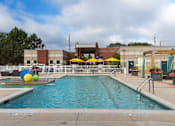 Thumbnail 19 of 47 - a swimming pool with a building in the background at Village Club of Rochester Hills, Shelby Township, MI