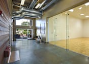 Thumbnail 22 of 47 - a large room with glass doors and a ping pong table at Village Club of Rochester Hills, Shelby Township