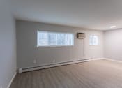 Thumbnail 7 of 10 - A room with a window and a wall-mounted air conditioner unit.