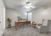 Thumbnail 3 of 50 - A room with a ceiling fan, a desk, a chair, and a potted plant.