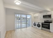 Thumbnail 5 of 33 - A kitchen with white cabinets and a microwave above the stove.