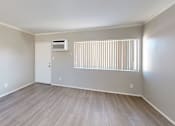 Thumbnail 8 of 10 - A room with a window and a wall-mounted air conditioner.