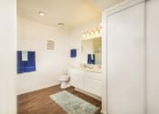 Thumbnail 11 of 17 - bathroom with a toilet and a sink and a mirror