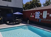 Thumbnail 13 of 14 - a swimming pool in front of a building