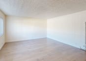 Thumbnail 12 of 12 - A room with wooden flooring and a window with blinds.