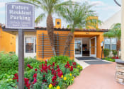 Thumbnail 25 of 37 - Leasing office entry with lush landscaping