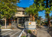 Thumbnail 1 of 17 - a building with a stonegate leasing center sign in front of it
