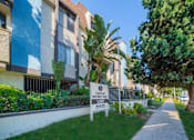 Thumbnail 13 of 19 - an apartment building with a sign in the grass in front