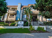 Thumbnail 1 of 19 - an apartment building with a sign in front of it