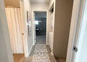 Thumbnail 19 of 35 - A hallway with a carpeted floor and a door on the right.