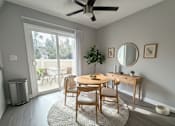 Thumbnail 29 of 35 - A room with a table, chairs, and a ceiling fan.