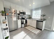 Thumbnail 18 of 35 - A modern kitchen with stainless steel appliances and white cabinets.