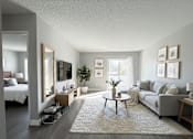 Thumbnail 13 of 35 - A well-lit, spacious living room with a grey couch, a coffee table, and a large mirror.