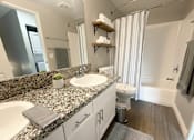 Thumbnail 14 of 35 - A bathroom with a sink, toilet, and bathtub.