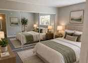 Thumbnail 9 of 20 - A bedroom with two beds and a nightstand.