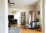 Thumbnail 9 of 35 - a living room with a couch and a tv in it