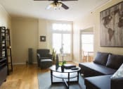 Thumbnail 10 of 35 - a living room with a couch and a coffee table