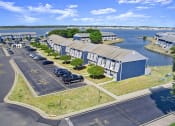 Thumbnail 34 of 35 - an aerial view of a building with a parking lot and a body of water