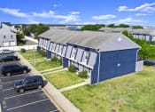 Thumbnail 32 of 35 - a blue house with a gray roof and a parking lot