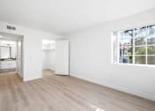 Thumbnail 59 of 67 - A spacious, empty room with white walls and a large window.