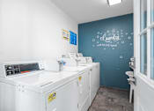 Thumbnail 45 of 67 - A laundry room with a washing machine and a dryer.