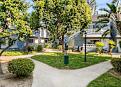 Thumbnail 1 of 67 - A residential grassy  area with a pathway and a green post.