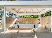 Thumbnail 26 of 67 - A white covered walkway with a bench in the middle.
