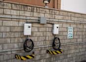 Thumbnail 46 of 67 - Two electric vehicle charging stations on a wall.