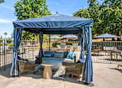 Thumbnail 24 of 67 - A blue cabana with striped umbrellas and a couch inside.