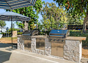 Thumbnail 37 of 67 - A stone wall with two grills on top.