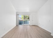 Thumbnail 60 of 67 - A room with a sliding glass door leading to a balcony.