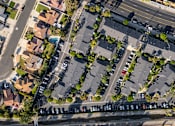 Thumbnail 51 of 67 - A street view of a residential area with houses and parked cars.