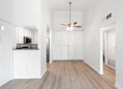 Thumbnail 58 of 67 - A modern kitchen with white cabinets and a wooden floor.
