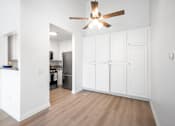Thumbnail 63 of 67 - A kitchen with white cabinets and a ceiling fan.