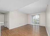 Thumbnail 11 of 49 - A room with wooden floors and white walls.