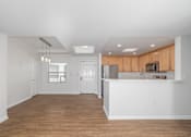 Thumbnail 19 of 49 - A kitchen with wooden cabinets and a white countertop.