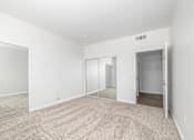 Thumbnail 15 of 49 - A room with a carpeted floor and a sliding glass door.