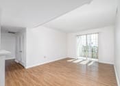 Thumbnail 9 of 49 - A room with wooden floors and white walls.